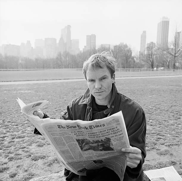 English singer-songwriter Sting reading the New York Times in Central Park on February 25, 1991.