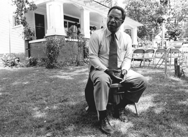 Author Alex Haley sits on a folding chair in the front yard of his childhood home, during a visit to Henning, TN, 1977.